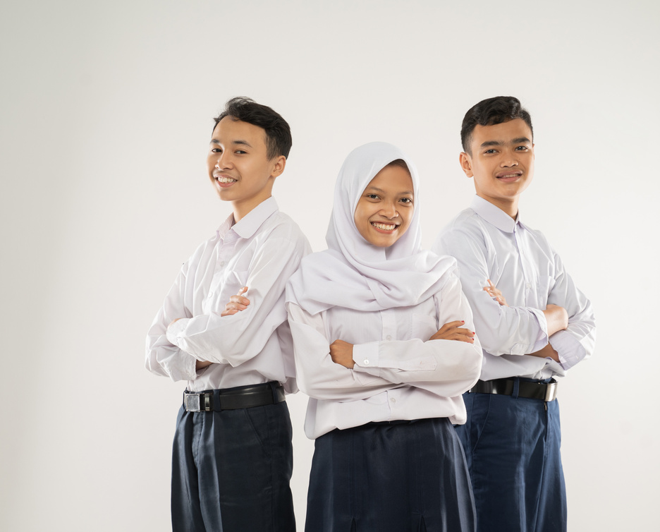 Three Teenagers in Junior High School Uniforms Stand Smiling with Crossed Hands